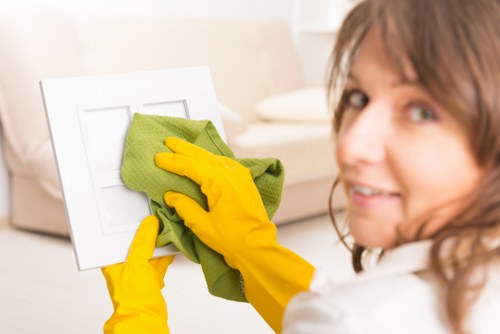 Cleaner preparing a room for carpet cleaning service